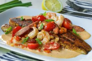 Blackened Redfish in a New Orleans style cream sauce with tender Shrimp, smoked Sausage, fresh tomatoes, onion and red peppers. Served over steamed rice.